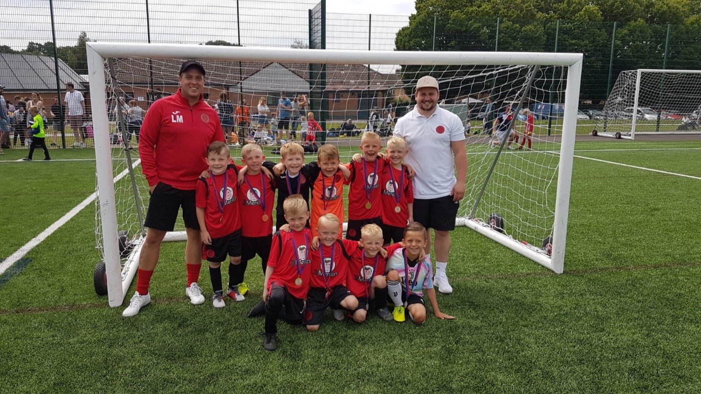 The JP Mentors sponsored youth football team in their red kit